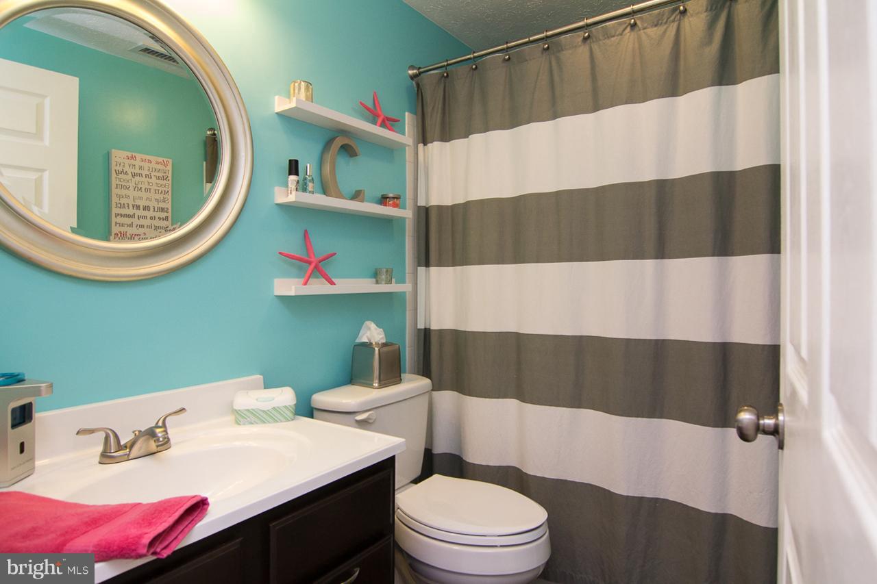 4122 Maple Path Circle, Unit 55 Baltimore, MD 21236 - Photo 20 of 27 a bathroom with a sink a toilet and a mirror