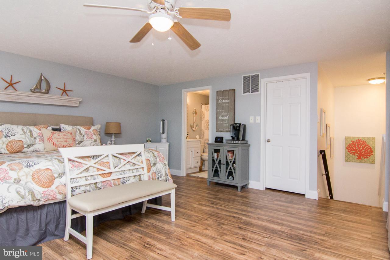 4122 Maple Path Circle, Unit 55 Baltimore, MD 21236 - Photo 23 of 27 a bedroom with a bed and wooden floor