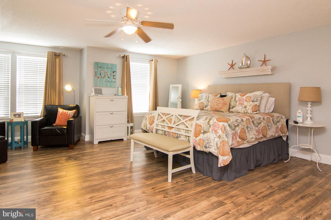 4122 Maple Path Circle, Unit 55 Baltimore, MD 21236 - Photo 24 of 27 a bedroom with a bed and a chandelier