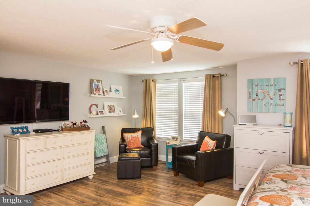 4122 Maple Path Circle, Unit 55 Baltimore, MD 21236 - Photo 25 of 27 a living room with furniture flat screen tv and a window