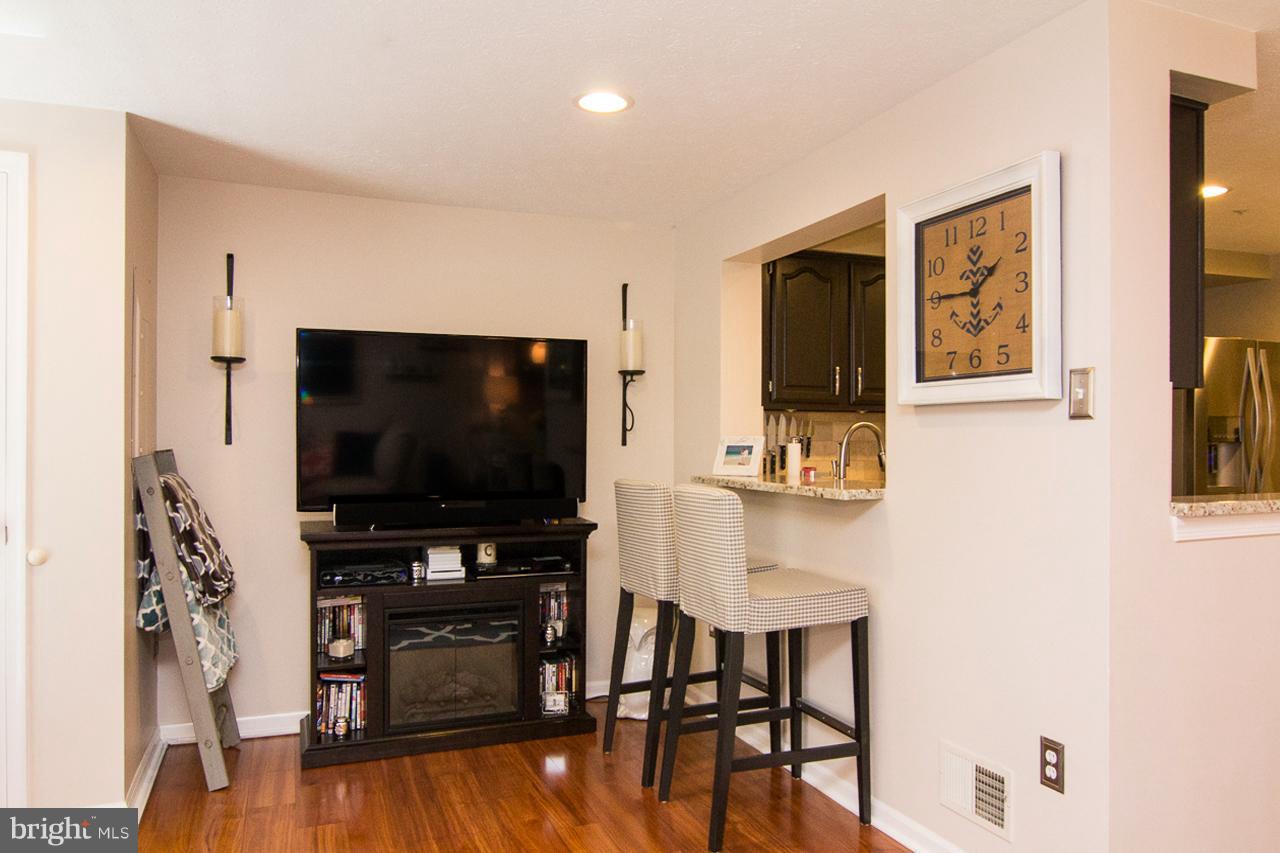 4122 Maple Path Circle, Unit 55 Baltimore, MD 21236 - Photo 8 of 27 a living room with furniture and a flat screen tv