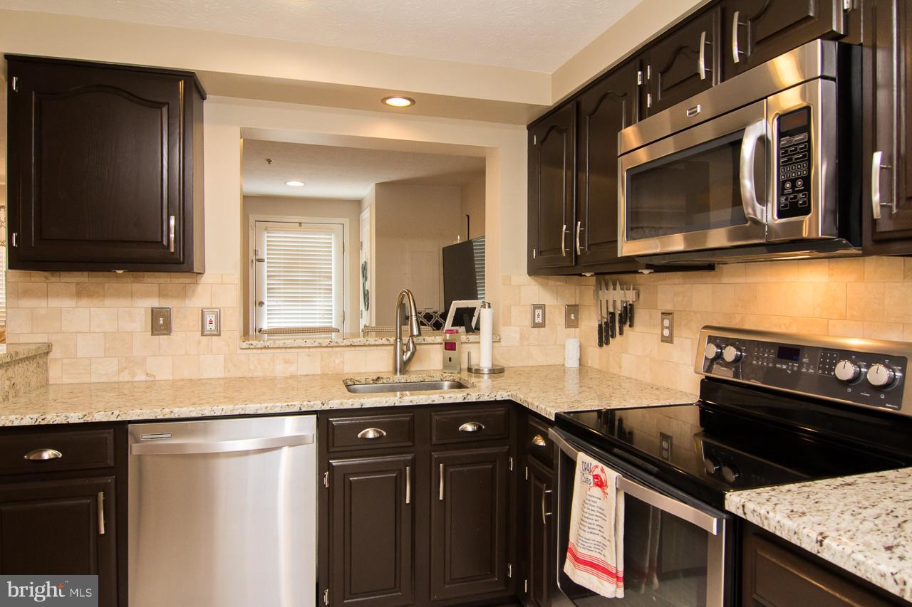 4122 Maple Path Circle, Unit 55 Baltimore, MD 21236 - Photo 9 of 27 a kitchen with a sink stove and microwave