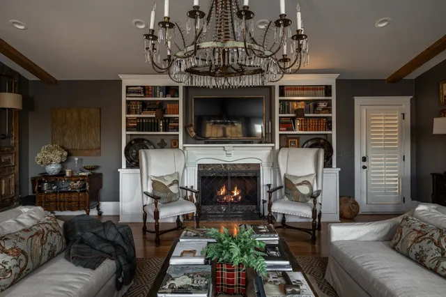 a living room with furniture and a chandelier