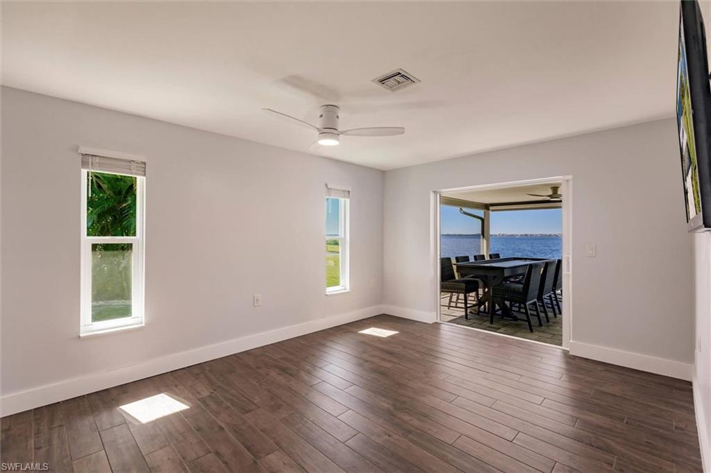 138 Riverview Road Fort Myers, FL 33905 - Photo 23 of 50 Spare room with ceiling fan, dark wood-style flooring, plenty of natural light, and visible vents