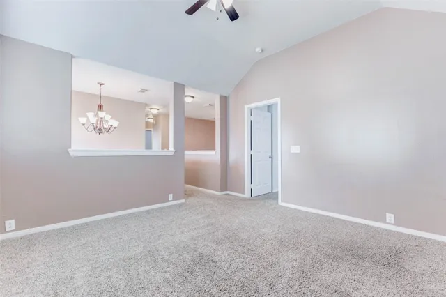 an empty room with closet and a ceiling fan