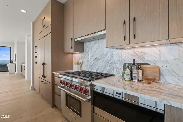 a living room with furniture and large windows