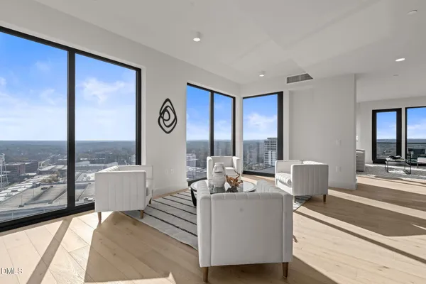 a living room with furniture and a view of kitchen
