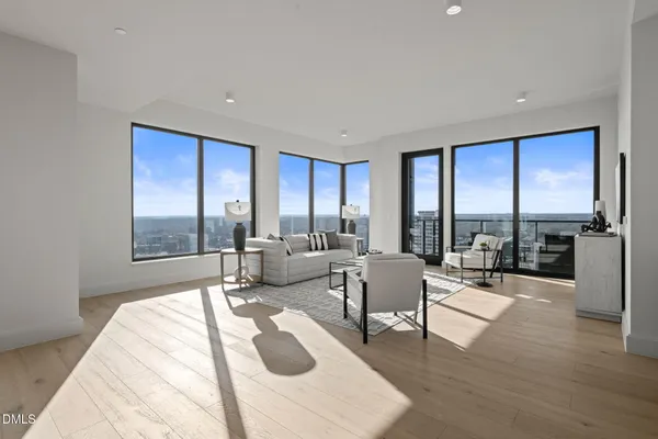 a living room with fireplace furniture and a wooden floor