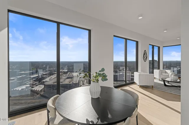 a living room with furniture wooden floor and a large window