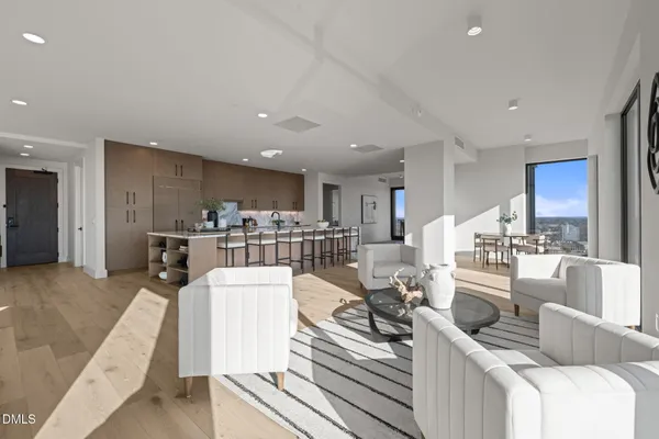 a dining room with furniture a rug and wooden floor