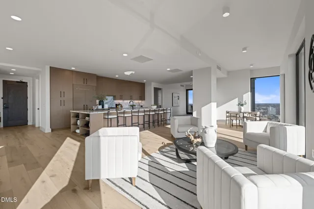 a dining room with furniture a rug and wooden floor