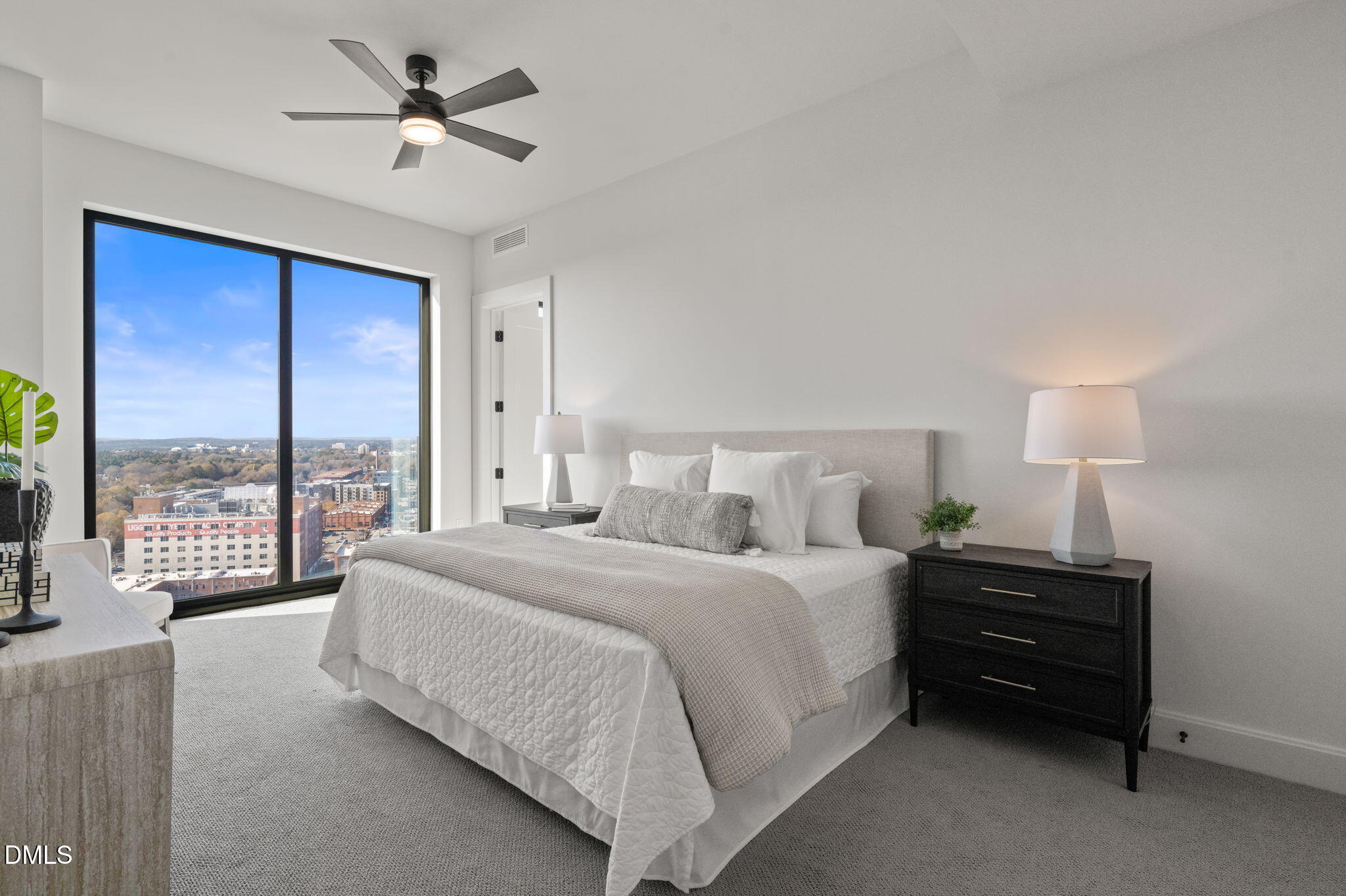 115 Morris Street, Unit 2205 Durham, NC 27701 - Photo 40 of 83 a bedroom with a large bed and a lamp on table