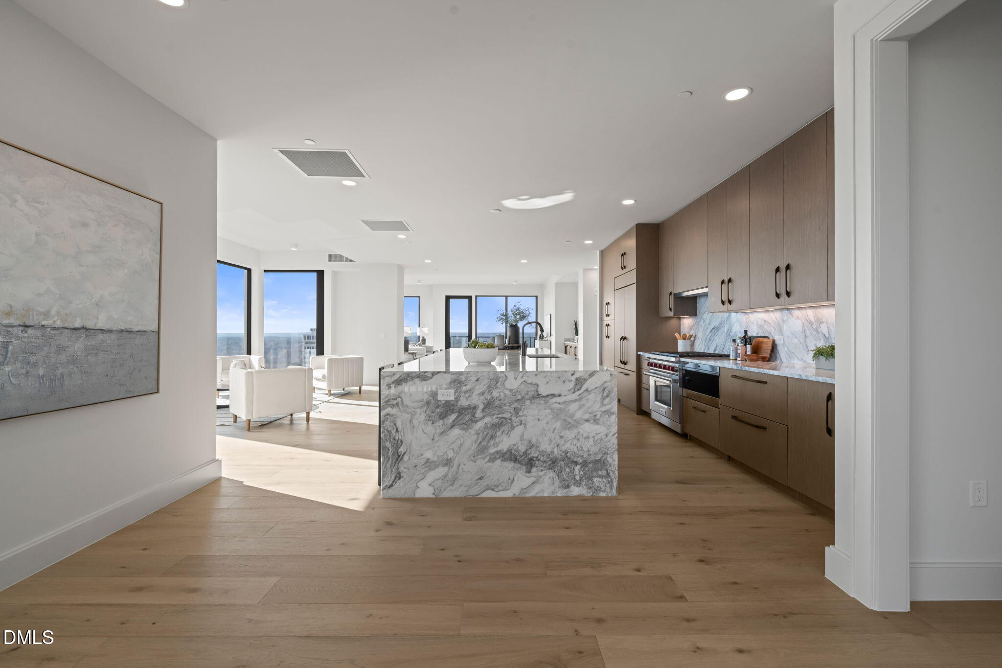 115 Morris Street, Unit 2205 Durham, NC 27701 - Photo 7 of 83 a large white kitchen with kitchen island a island a sink a stove and a refrigerator