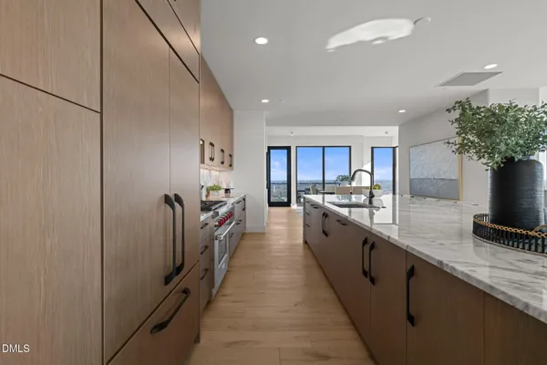 a kitchen with granite countertop a stove and a sink