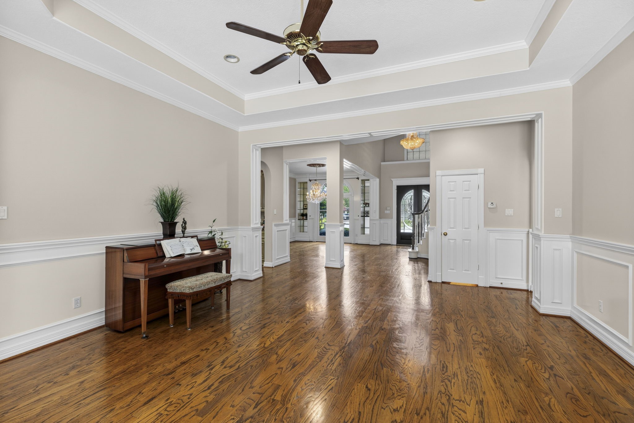 18310 Pamela Way Spring, TX 77379 - Photo 8 of 42 Bright open view from the living area back to the dining and grand foyer, showcasing the seamless flow and expansive layout of the main floor.
