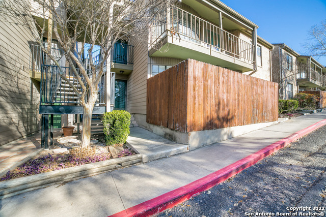 a front view of a building with tree