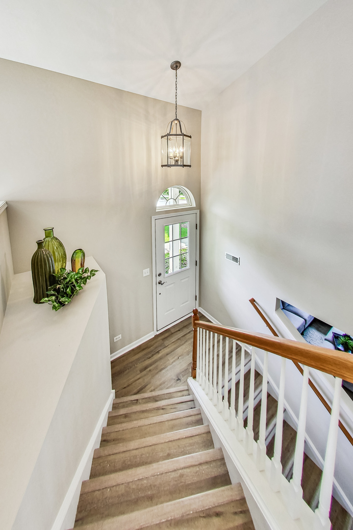 1052 Reserve Drive Elgin, IL 60123 - Photo 9 of 40 a view of entryway and hall with wooden floor