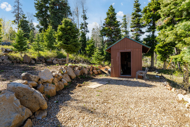 706 Tranquility Drive Springdale, UT 84767 - Photo 29 of 55 Rock Landscaping & Outbuilding: Custom rock retaining walls frame the path to the versatile storage shed.