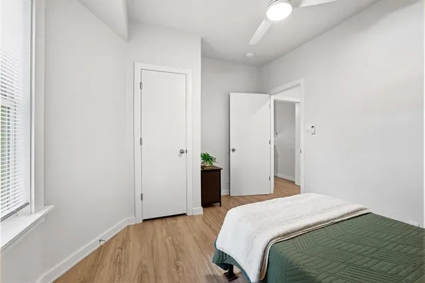 a bedroom with a bed and a window