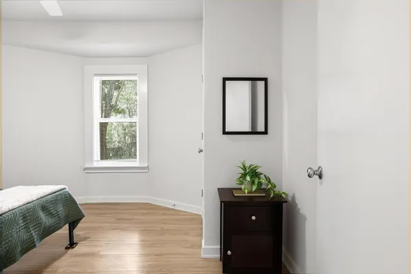 a living room with a bed and a window