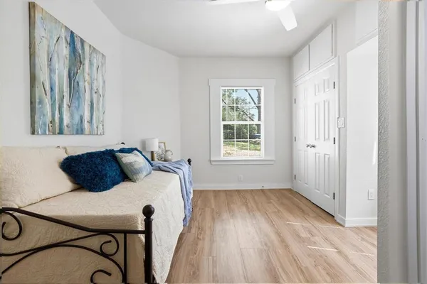 a bed sitting in a bedroom next to a window