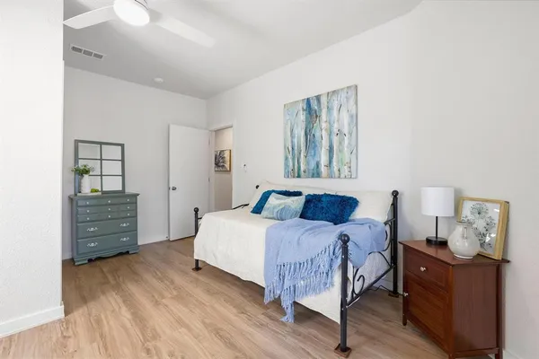 a bedroom with a bed and wooden floor