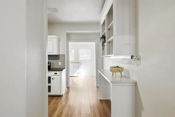 a kitchen with granite countertop a sink stainless steel appliances and window