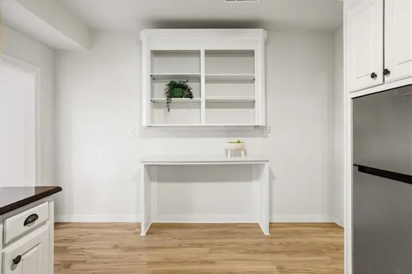 a view of a room that has a table and chair in it