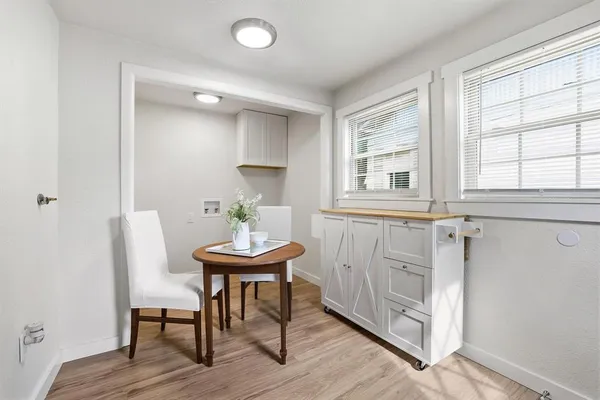 a view of a room that has a table and a chair