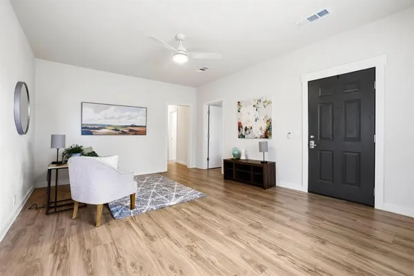 a living room with furniture and wooden floor