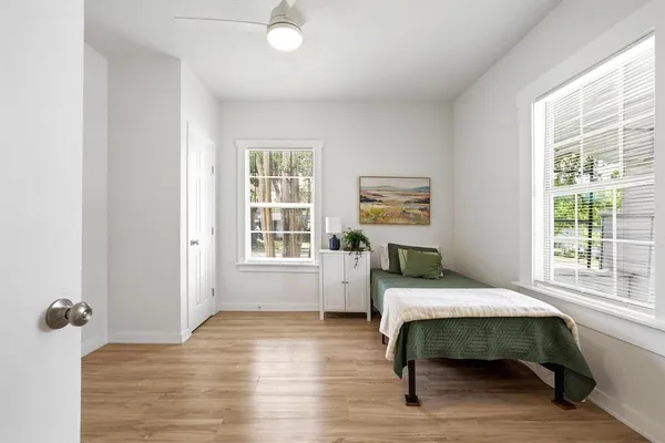a bedroom with furniture and a window