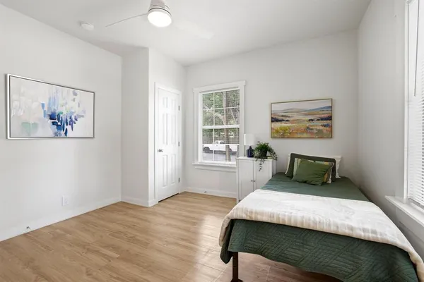a bedroom with a large bed and a window