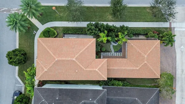 a aerial view of a house with a yard and potted plants