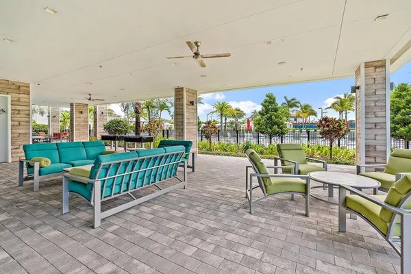 a view of a porch with furniture and a yard