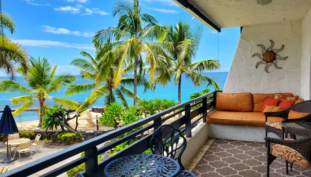 a view of a chairs and table in a balcony