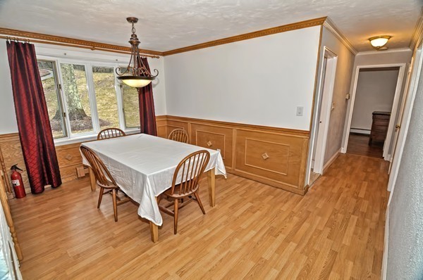 10 Edith Road Framingham, MA 01701 - Photo 11 of 30 a living room with a table chairs and wooden floor