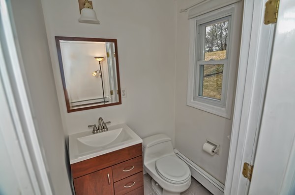 10 Edith Road Framingham, MA 01701 - Photo 20 of 30 a bathroom with a toilet a sink and mirror