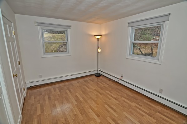 10 Edith Road Framingham, MA 01701 - Photo 21 of 30 a view of an empty room with a window and wooden floor