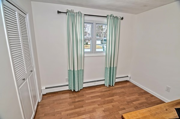 10 Edith Road Framingham, MA 01701 - Photo 23 of 30 an empty room with wooden floor and a window