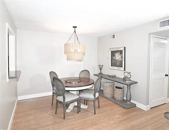 a view of a a dining room with furniture window and wooden floor
