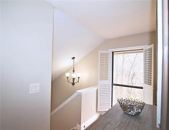 a view of a room with wooden floor and a potted plant
