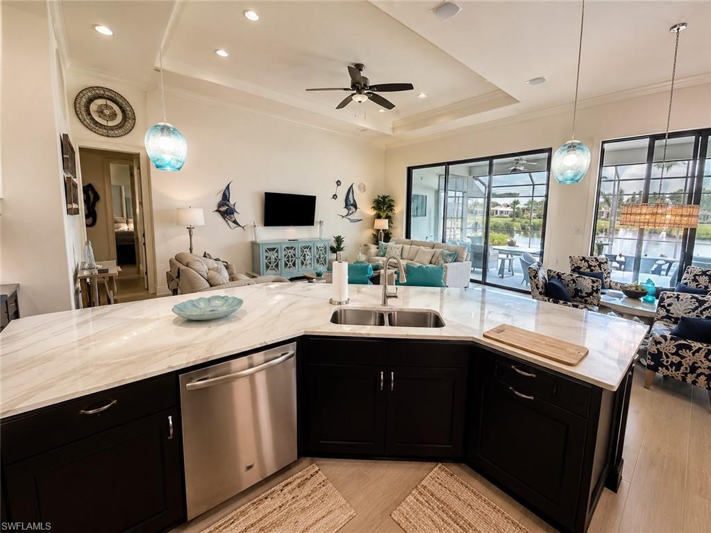 6574 Amarone Lane Naples, FL 34113 - Photo 9 of 44 a kitchen with a sink appliances and a counter top space