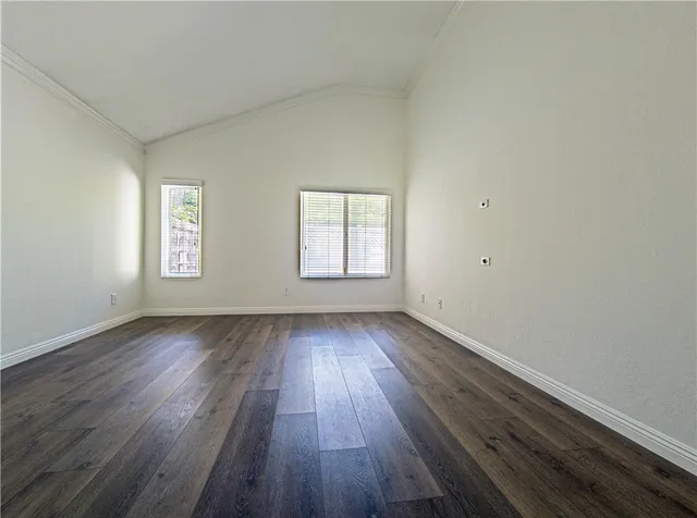 an empty room with wooden floor and window