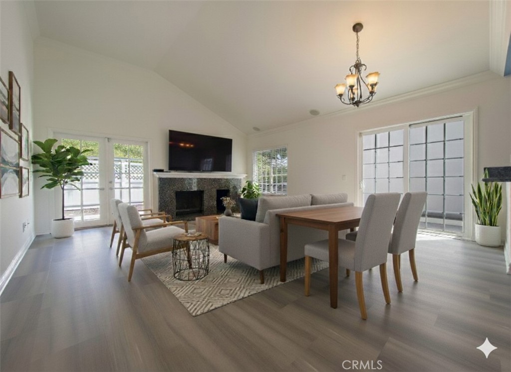 21032 Primrose Lane Mission Viejo, CA 92691 - Photo 10 of 19 a view of a livingroom and dining room with furniture wooden floor and a fireplace