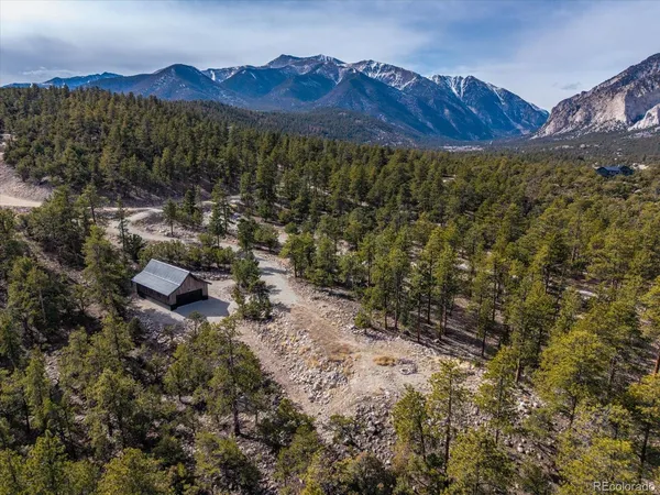 a view of a house with a mountain and a forest