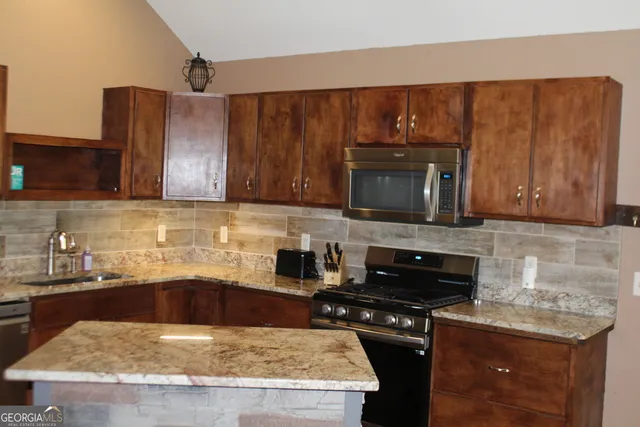 a kitchen with wooden cabinets and a stove top oven