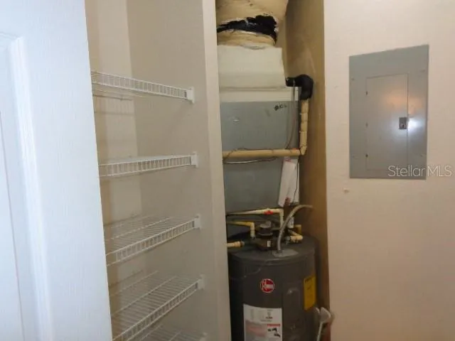 a room with a walk in closet and wooden door