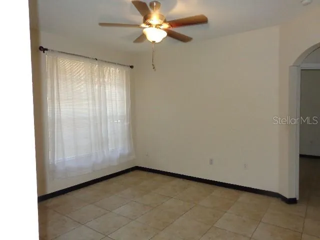 a view of room with window and ceiling fan