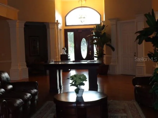 a view of living room with furniture and a mirror