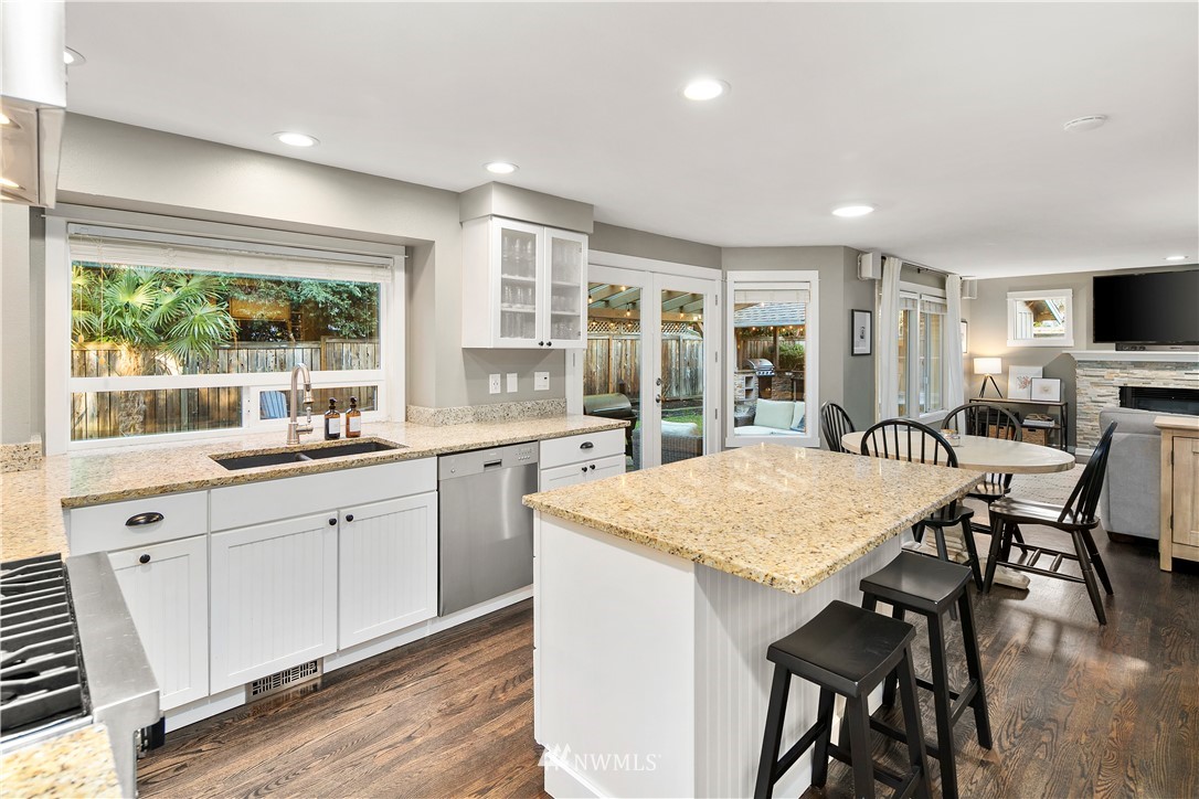 3121 210th Street Southeast Bothell, WA 98021 - Photo 11 of 40 a kitchen with granite countertop stainless steel appliances a table and chairs in it
